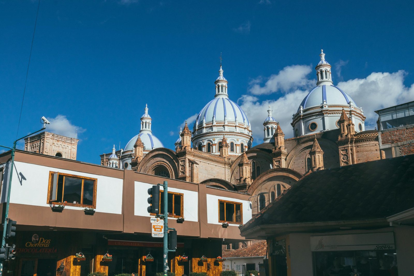 Magnificent view of Cuenca's Cathedral with iconic domes and clear blue sky.
